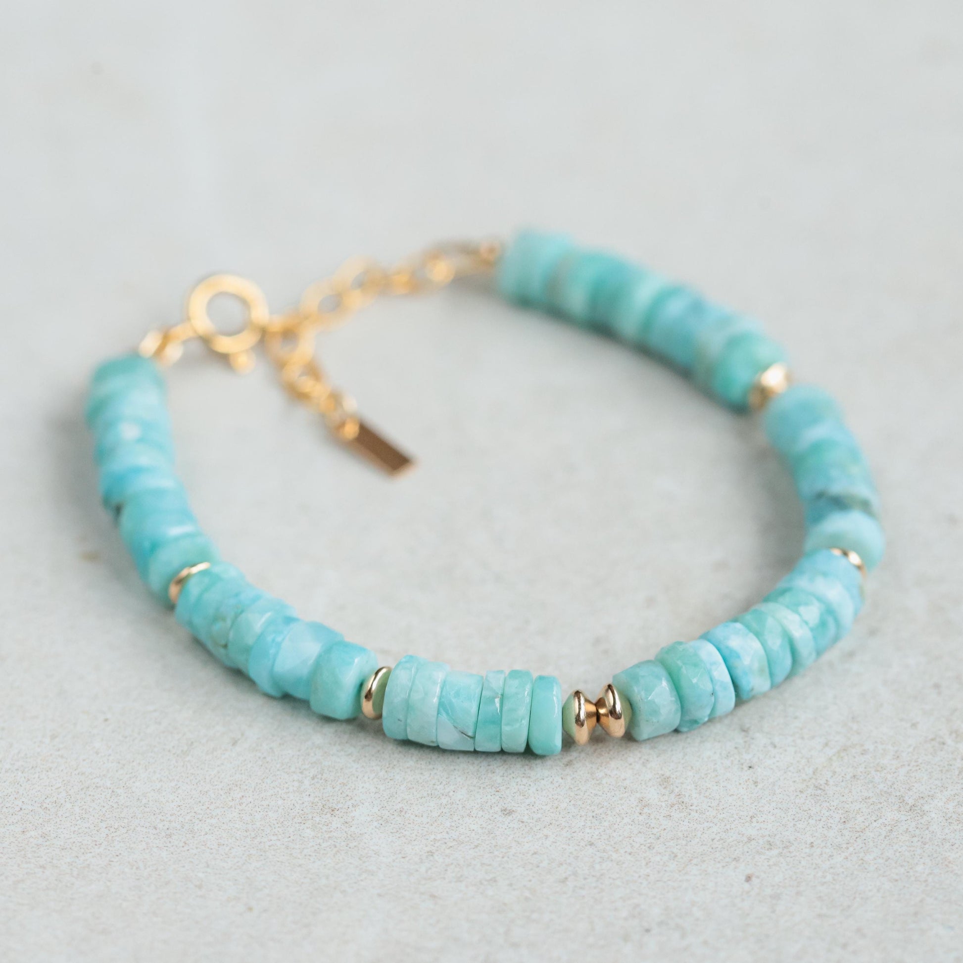 Larimar Heishi bracelet with 14K gold-filled beads, featuring smooth blue stone discs on a delicate gold-filled chain.