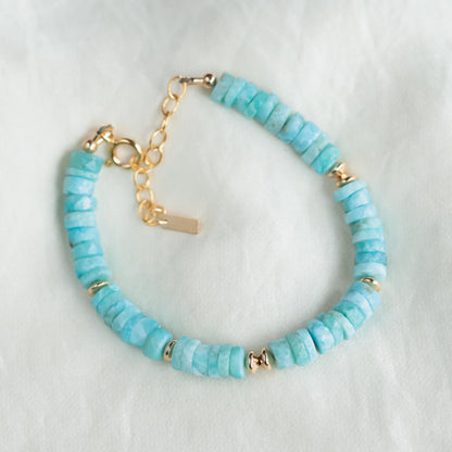 Larimar Heishi bracelet with 14K gold-filled accents, featuring smooth blue stone beads, crafted by Earthly Abundance.