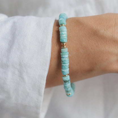 Larimar Heishi bracelet with 14K gold-filled accents from Earthly Abundance, featuring smooth blue stone beads on a delicate string.