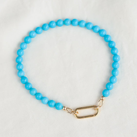 14K Sleeping Beauty Carabiner Bracelet by Earthly Abundance featuring a polished gold finish and intricate design.