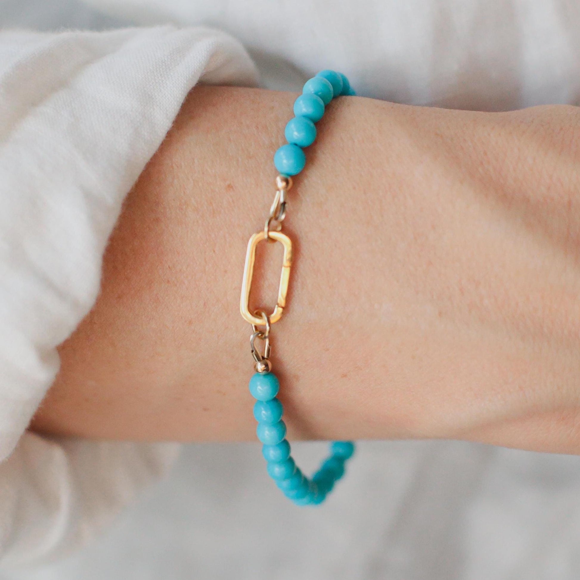14K Sleeping Beauty Carabiner Bracelet by Earthly Abundance featuring a polished gemstone and secure clasp design.