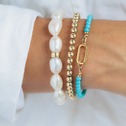 14K Sleeping Beauty Carabiner Bracelet by Earthly Abundance featuring a detailed Sleeping Beauty turquoise stone and silver hardware.
