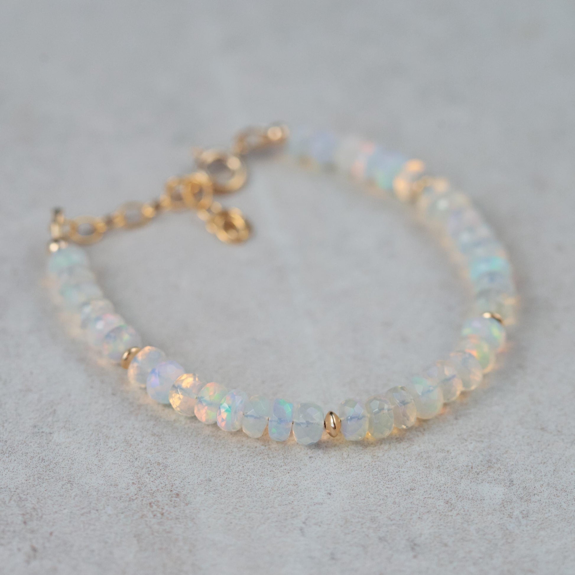 Dainty Ethiopian Welo Opal bracelet with 14K gold setting from Earthly Abundance, featuring a delicate design and vibrant opal stones.