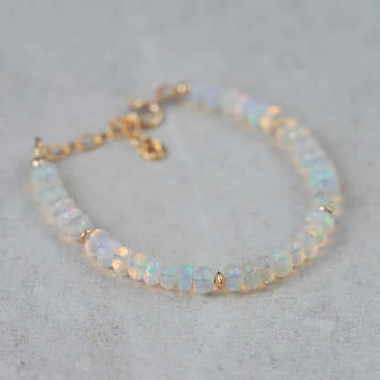Dainty Ethiopian Welo Opal bracelet with 14K gold setting from Earthly Abundance, featuring a delicate design and vibrant opal stones.