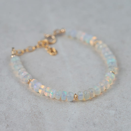 Ethiopian Welo Opal dainty bracelet with 14K gold setting, featuring vibrant opal stones on a delicate chain.