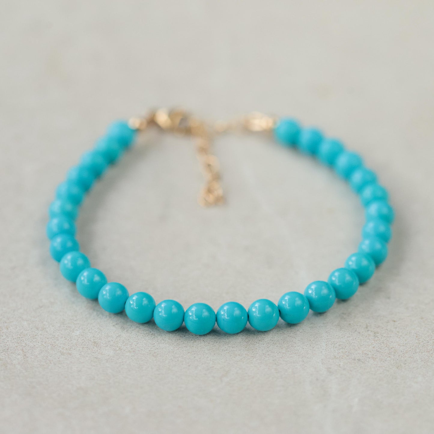 Adjustable Sleeping Beauty turquoise ring in 14K gold from Earthly Abundance, featuring vibrant blue turquoise gemstone.