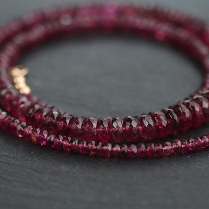 Rosé Ember Pink Tourmaline necklace in 14K gold with a delicate pendant, showcasing a vibrant pink gemstone on a fine chain.