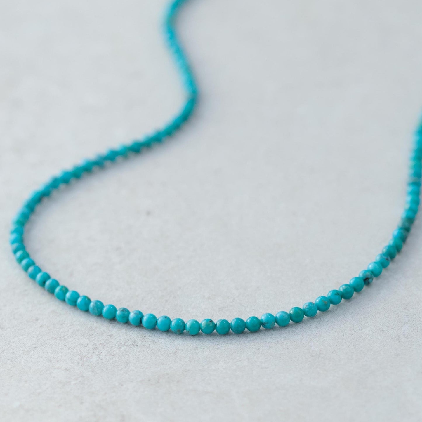 Earthly Abundance Kingman turquoise necklace with 14K gold chain, featuring vibrant turquoise stones and elegant jewelry design.