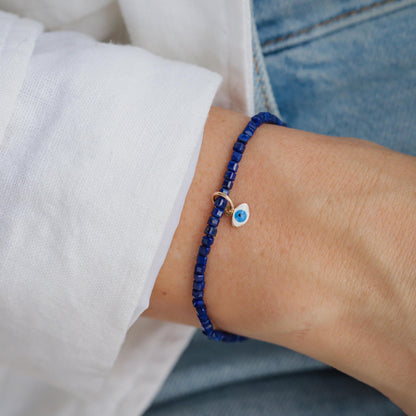 Lapis Lazuli Evil Eye pendant in 14K gold from Earthly Abundance, featuring a vibrant blue gemstone with protective evil eye design.