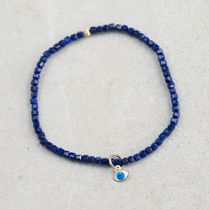 Lapis Lazuli Evil Eye pendant in 14K gold from Earthly Abundance, featuring a vibrant blue gemstone with gold accents.