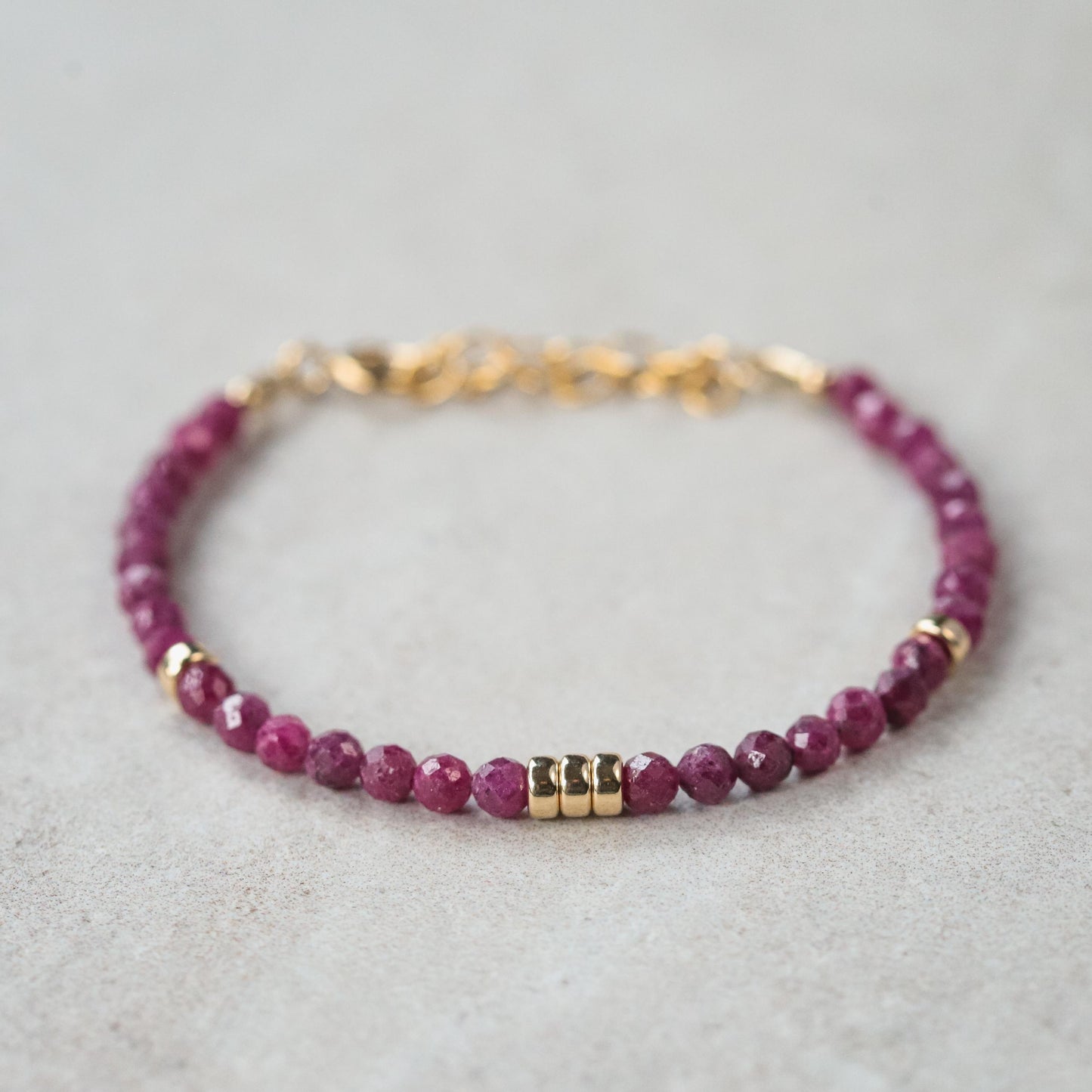 Elegant Wild Berry Ruby bracelet in 14K gold from Earthly Abundance featuring vibrant ruby stones and delicate gold links.
