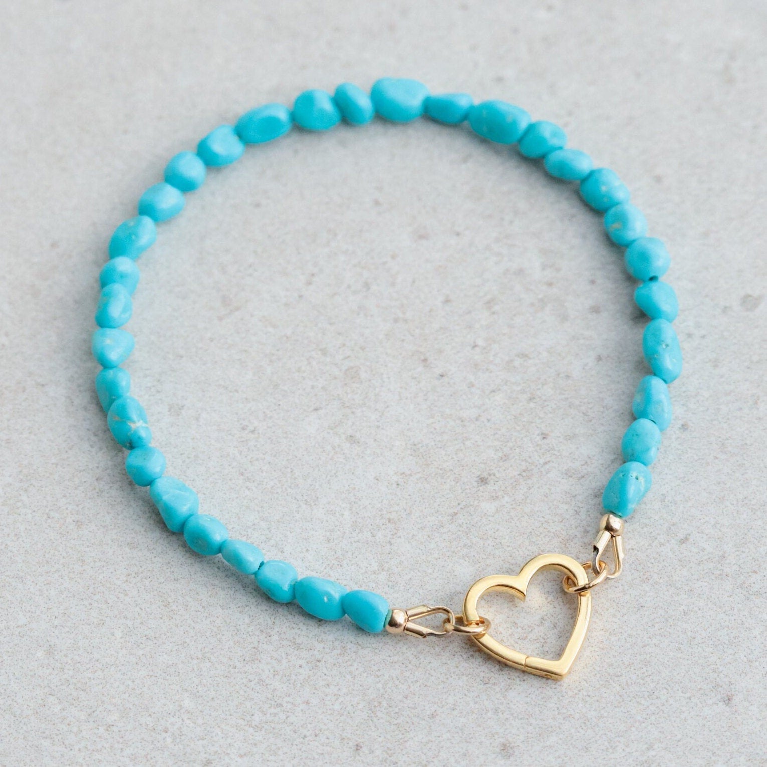 Sleeping Beauty turquoise heart bracelet by Earthly Abundance featuring turquoise heart-shaped beads on a silver chain.