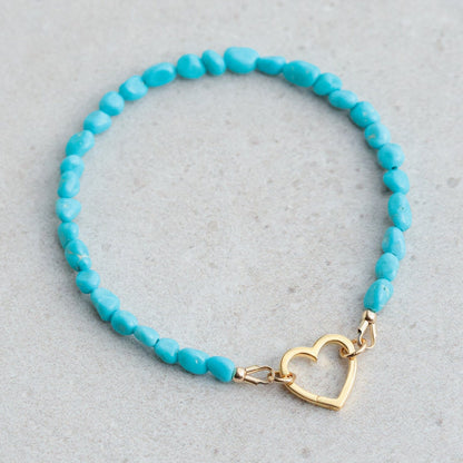 Sleeping Beauty turquoise heart bracelet by Earthly Abundance featuring turquoise heart-shaped beads on a silver chain.