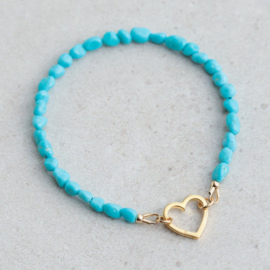 Sleeping Beauty turquoise heart bracelet by Earthly Abundance featuring turquoise heart-shaped beads on a silver chain.