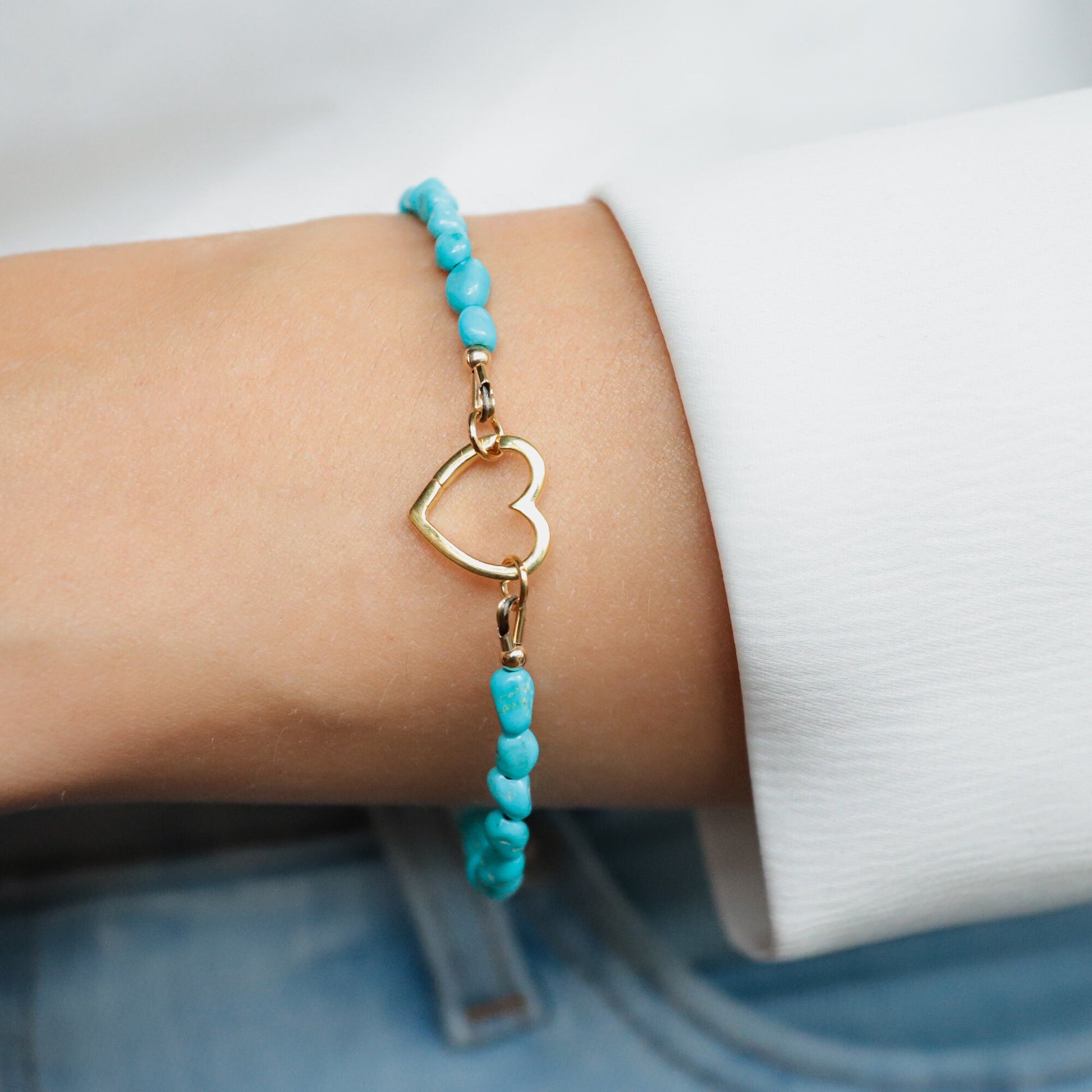 Sleeping Beauty turquoise heart bracelet by Earthly Abundance featuring a silver chain and vibrant turquoise heart pendant.