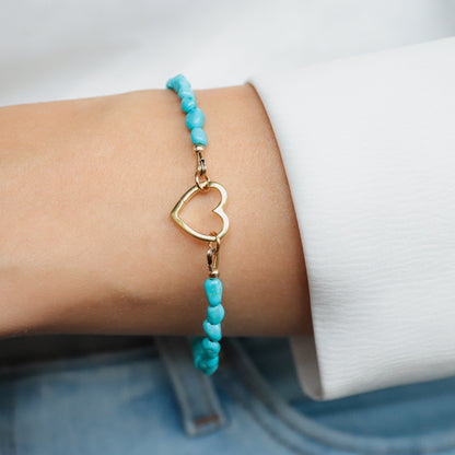 Sleeping Beauty turquoise heart bracelet by Earthly Abundance featuring a silver chain and vibrant turquoise heart pendant.