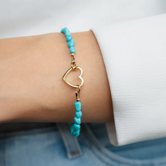 Sleeping Beauty turquoise heart bracelet by Earthly Abundance featuring a silver chain and vibrant turquoise heart pendant.