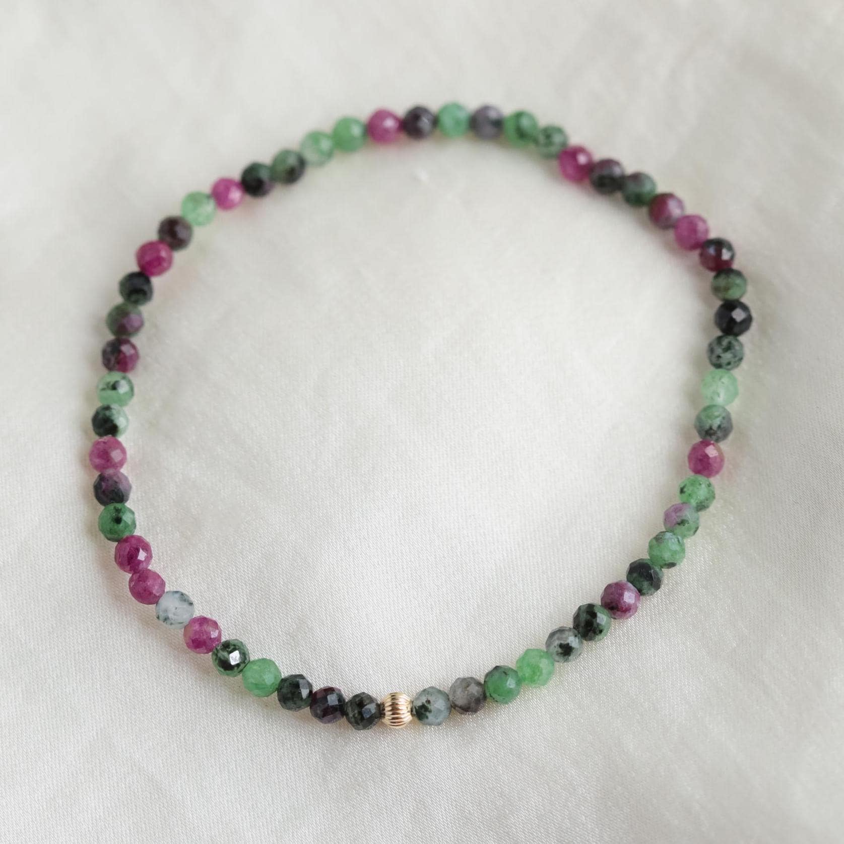 Ruby Zoisite 3mm beads from Earthly Abundance, showcasing vibrant red and green gemstone strands.