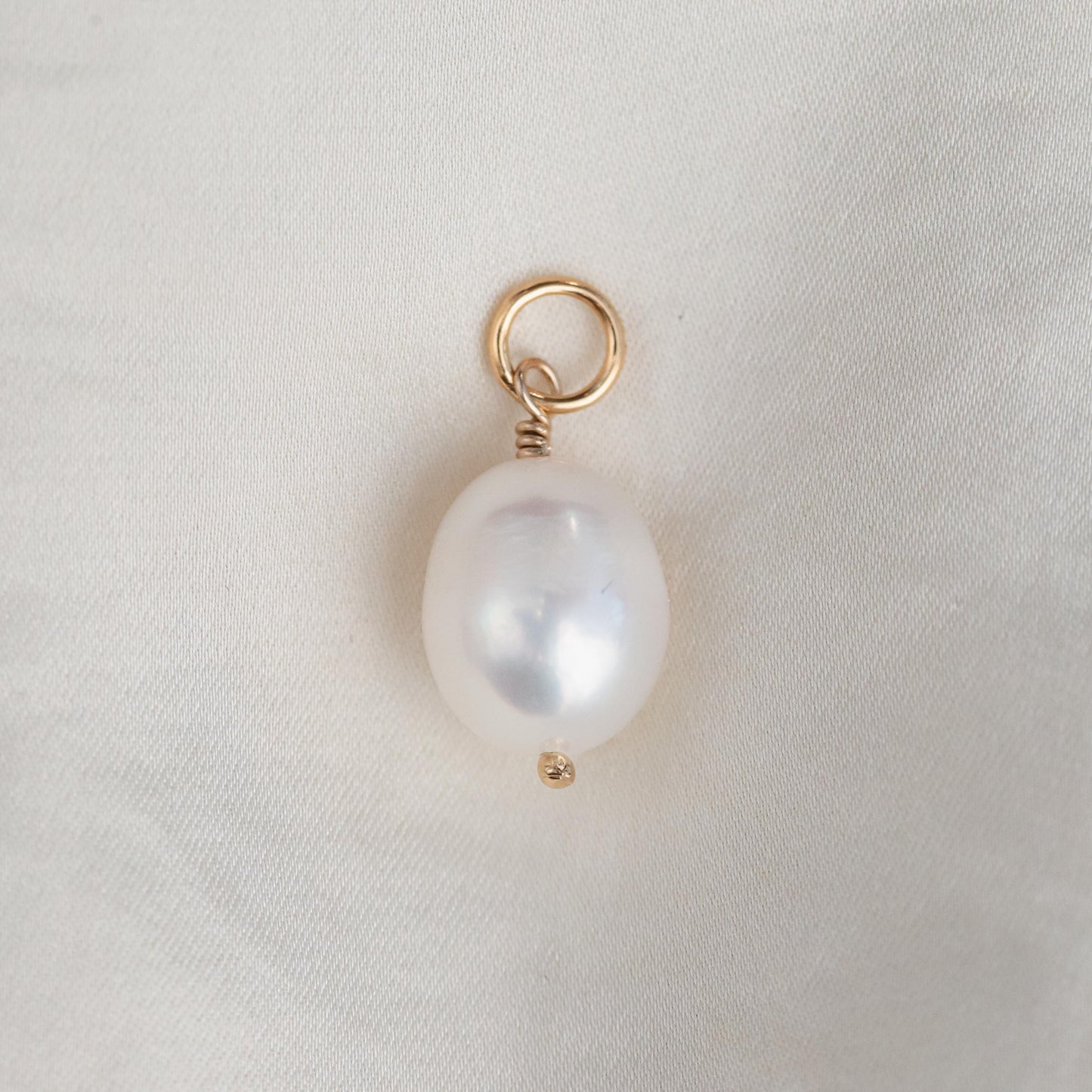 Freshwater pearl pendant in 14K gold from Earthly Abundance, featuring a smooth, lustrous pearl hanging from a delicate gold chain.