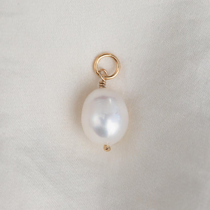 Freshwater pearl pendant in 14K gold from Earthly Abundance, featuring a smooth, lustrous pearl hanging from a delicate gold chain.