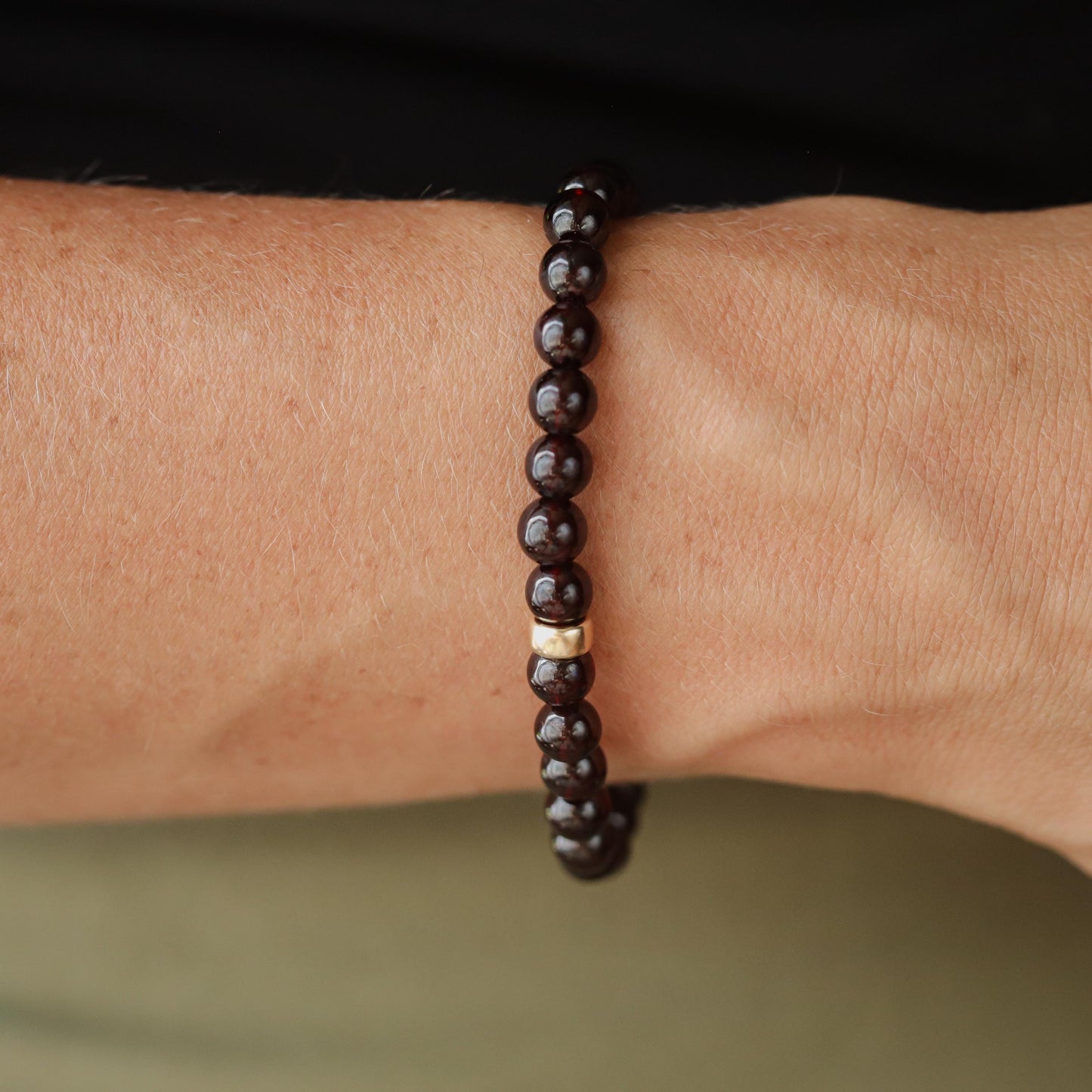 Garnet bracelet with 6mm round gemstones on a 14K gold chain, handcrafted by Earthly Abundance.