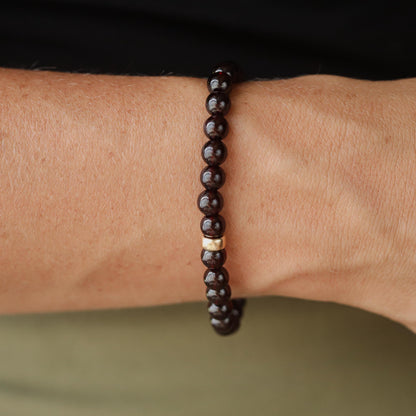 Garnet bracelet with 6mm round gemstones on a 14K gold chain, handcrafted by Earthly Abundance.