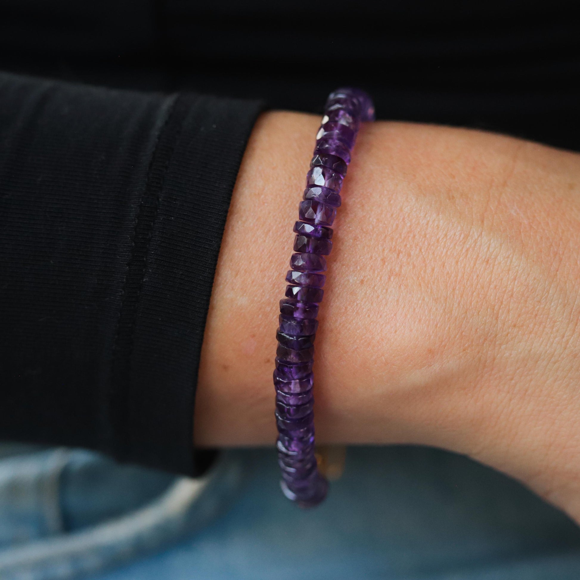 Earthly Abundance amethyst Heishi bracelet featuring small purple gemstone beads on a stretchy cord.