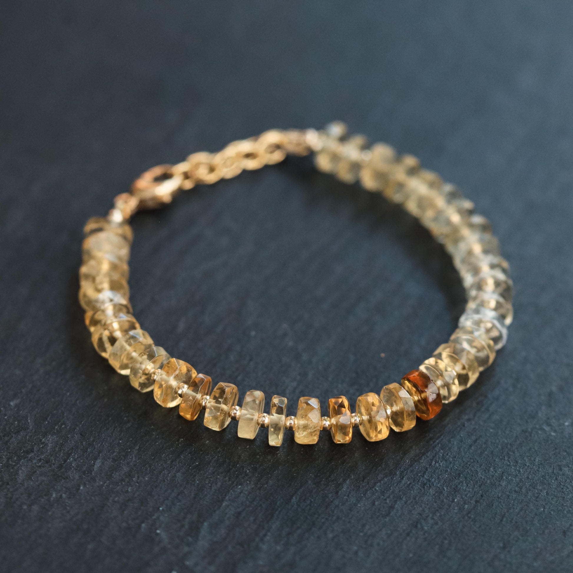 Citrine ombré pendant crafted with 14K gold-filled setting, featuring a gradient of orange and yellow citrine stones.