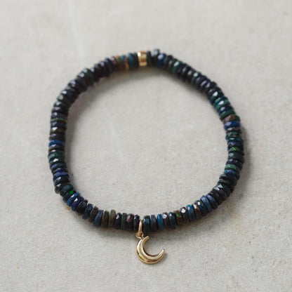 Black Opal Moon Bracelet in 14K gold with moon-shaped charms, featuring colorful opal stones on a delicate gold chain.