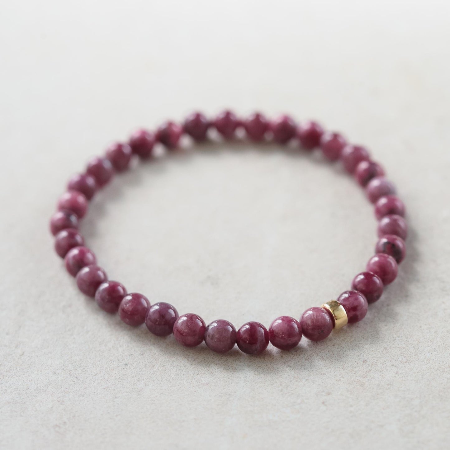 Elegant 5mm ruby bracelet in 14K gold featuring vibrant red rubies, crafted by Earthly Abundance.