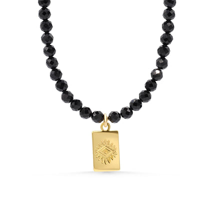 Black tourmaline evil eye necklace with a protective pendant on a silver chain, designed by Earthly Abundance.