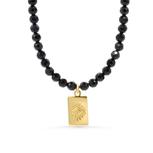 Black tourmaline evil eye necklace with a protective pendant on a silver chain, designed by Earthly Abundance.