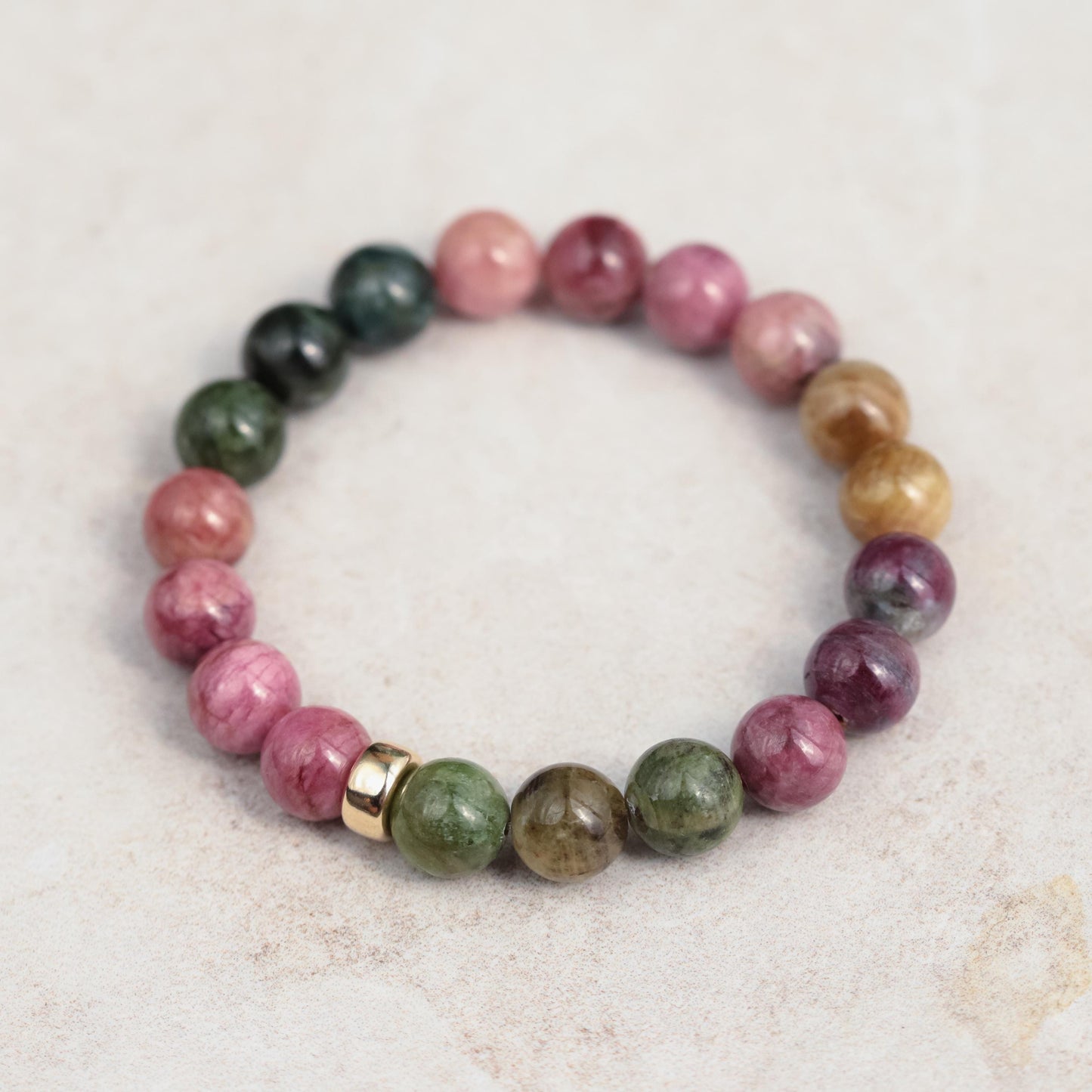 Mixed tourmaline strength bracelet with 14K gold setting, featuring colorful tourmaline gemstones and a delicate clasp.