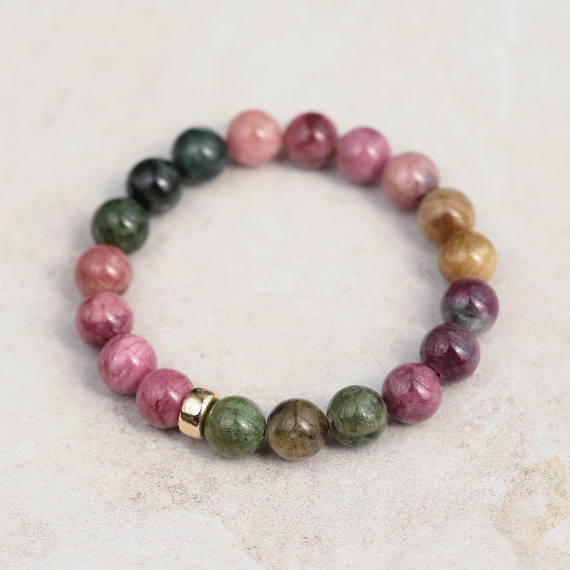 Mixed tourmaline strength bracelet with 14K gold setting, featuring colorful tourmaline gemstones and a delicate clasp.
