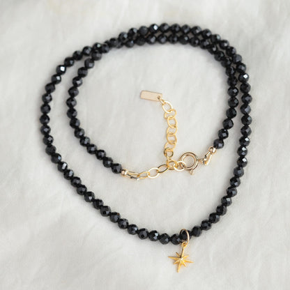 Black Spinel North Star Necklace by Earthly Abundance featuring a shimmering black spinel star pendant on a delicate chain.