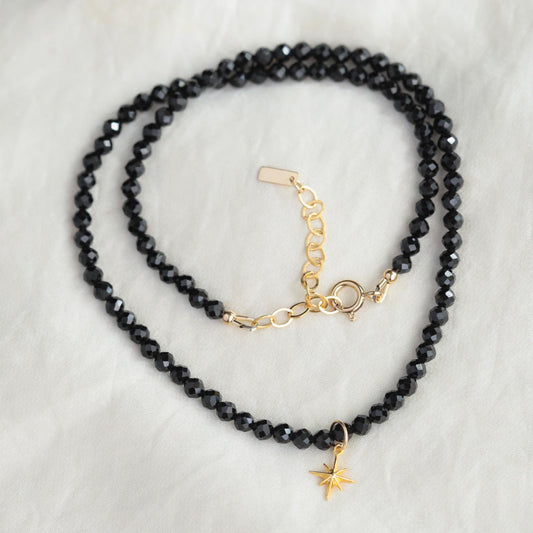 Black Spinel North Star Necklace by Earthly Abundance featuring a shimmering black spinel star pendant on a delicate chain.