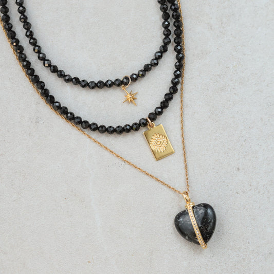 Black Spinel North Star Necklace by Earthly Abundance featuring a dark gemstone pendant on a delicate chain.