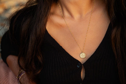 Greek style pendant necklace by Earthly Abundance featuring a detailed pendant on a delicate chain.