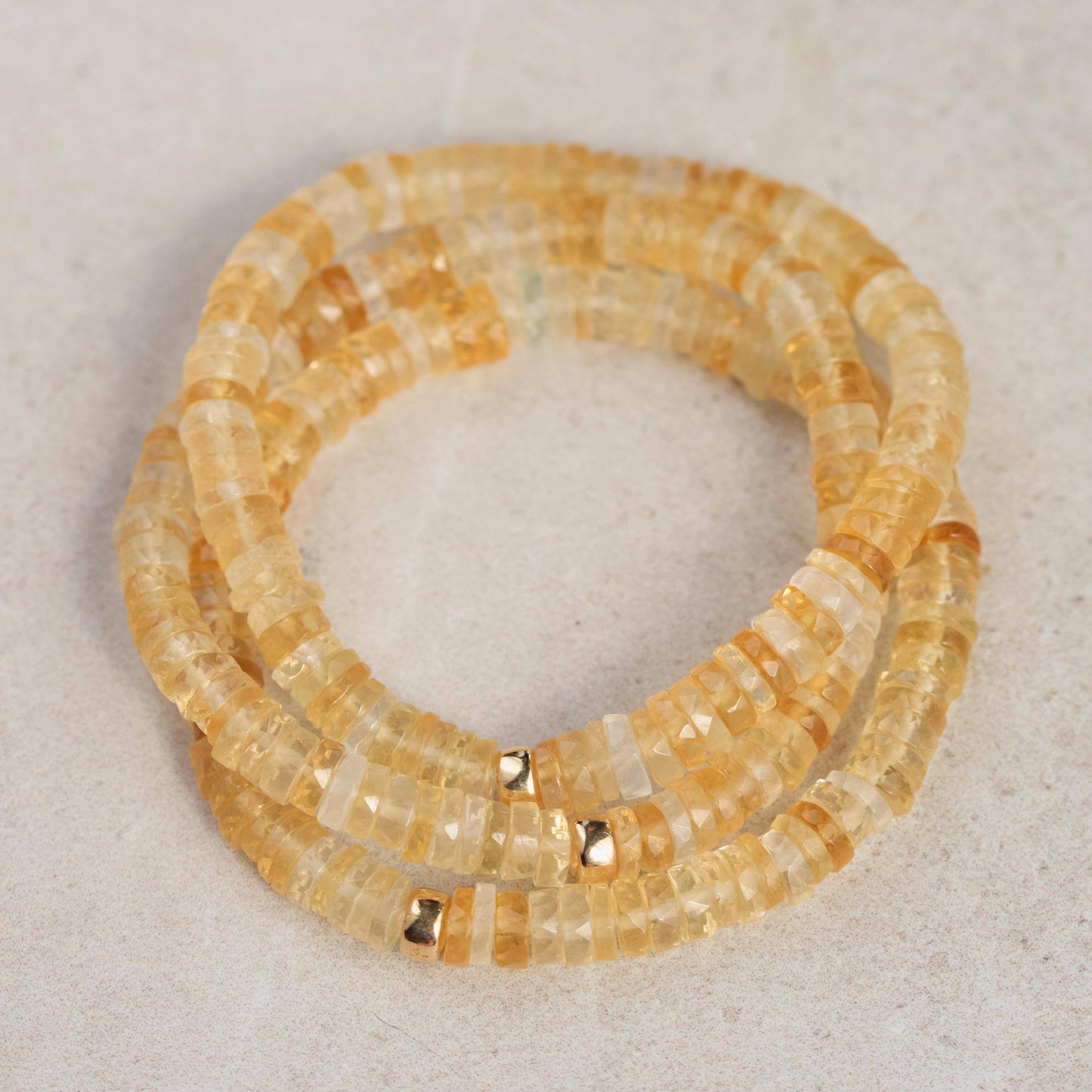 Citrine Heishi bracelet by Earthly Abundance featuring small, smooth yellow gemstone beads on a stretch cord.