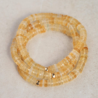Citrine Heishi bracelet by Earthly Abundance featuring small, smooth yellow gemstone beads on a stretch cord.