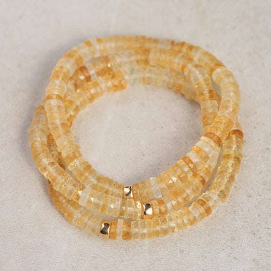 Citrine Heishi bracelet by Earthly Abundance featuring small, smooth yellow gemstone beads on a stretch cord.