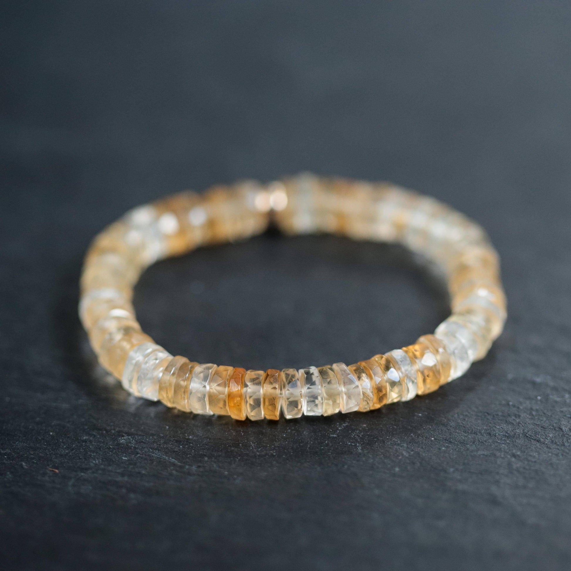 Citrine Heishi bracelet by Earthly Abundance featuring small, orange-yellow gemstone beads on a stretchy elastic band.