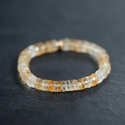 Citrine Heishi bracelet by Earthly Abundance featuring small, orange-yellow gemstone beads on a stretchy elastic band.
