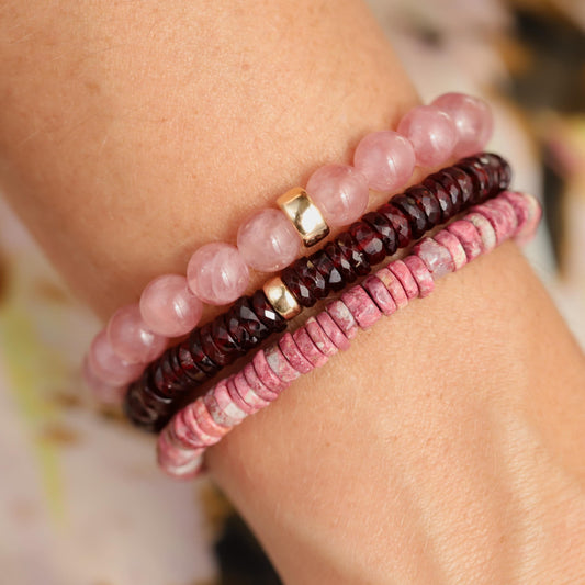 Earthly Abundance Garnet Heishi bracelet featuring small, polished red garnet beads strung on a stretch cord.
