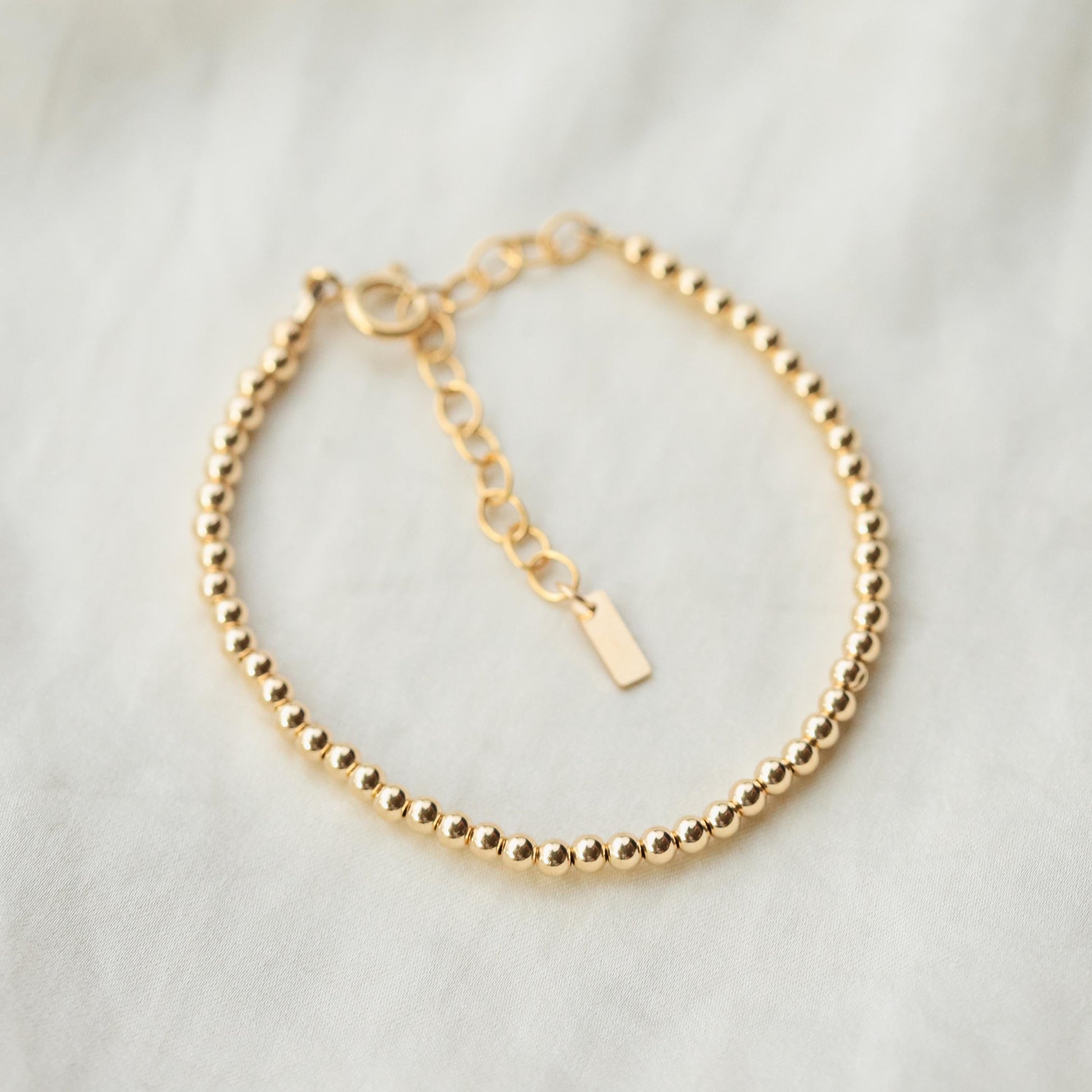 Adjustable gold filled beaded ball bracelet by Earthly Abundance featuring small round beads on a delicate chain.