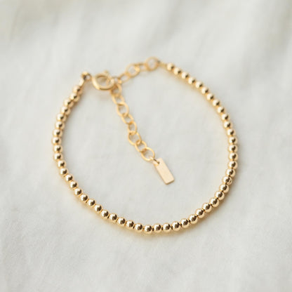 Adjustable gold filled beaded ball bracelet by Earthly Abundance featuring small round beads on a delicate chain.