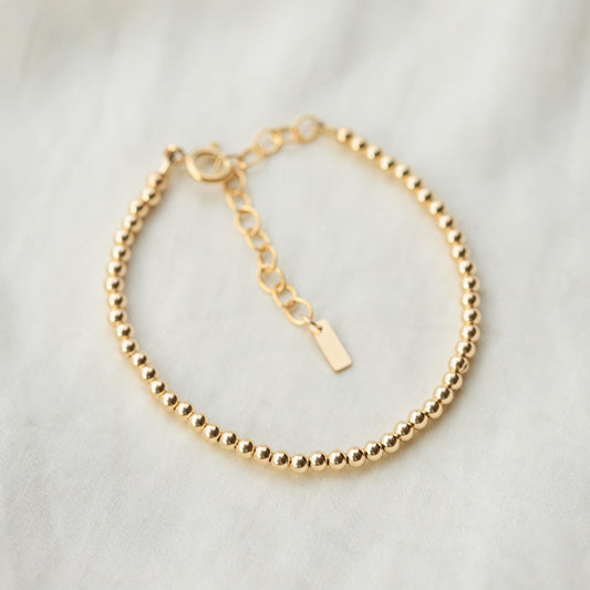 Adjustable gold filled beaded ball bracelet by Earthly Abundance featuring small round beads on a delicate chain.