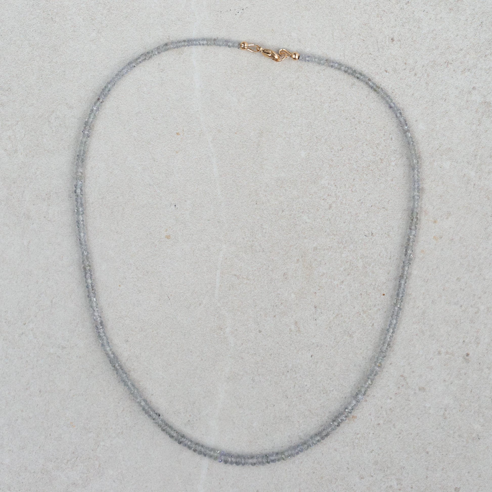 Grey sapphire necklace in 14K gold from Earthly Abundance featuring a delicate chain with a central grey sapphire pendant.