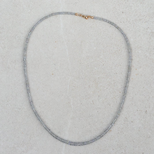Grey sapphire necklace in 14K gold featuring a delicate pendant, displayed on a neutral background.