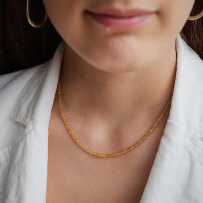 Yellow sapphire necklace in 14K gold featuring a radiant yellow sapphire pendant, styled with a delicate chain.